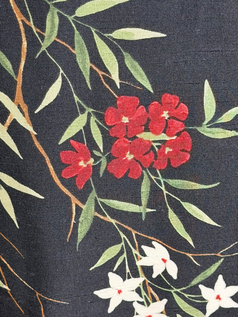 Black silk sheath dress by Dolce & Gabbana, sleeveless construction with coral and olive tones floral