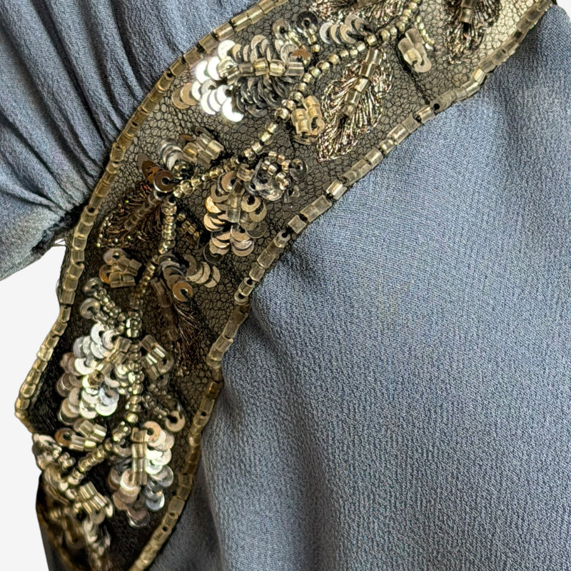 Side view of Valentino dress displaying ruched seam and fitted silhouette through hip