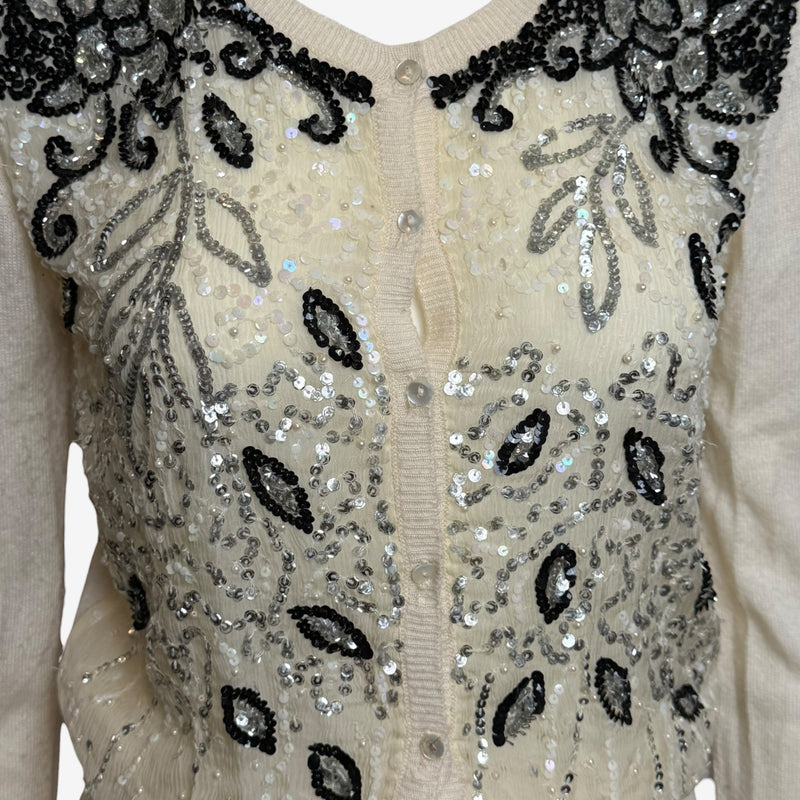 Cream Blumarine cardigan side profile with fitted silhouette and ribbed cuffs