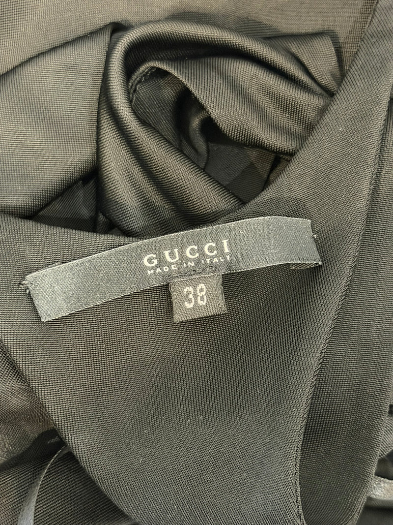 Black jersey halter gown by Gucci, floor-length hem detail with subtle flare