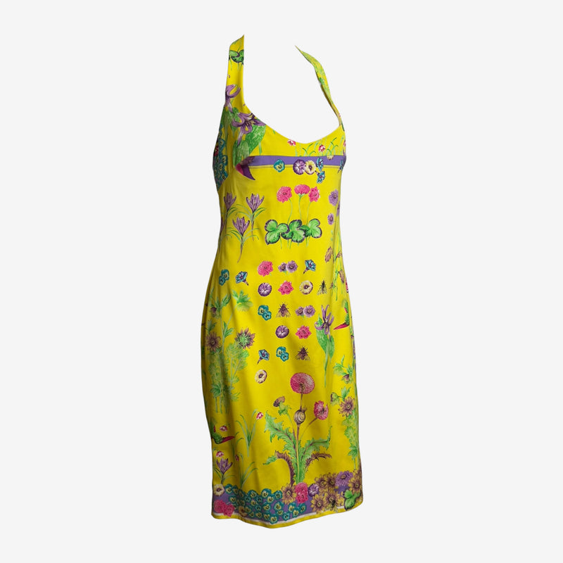 Yellow silk halter dress by Versace with botanical print, detail of empire waistline and purple ribbon trim