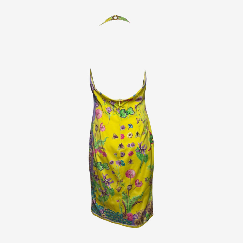 Yellow silk halter dress by Versace, side view of fitted silhouette and midi length
