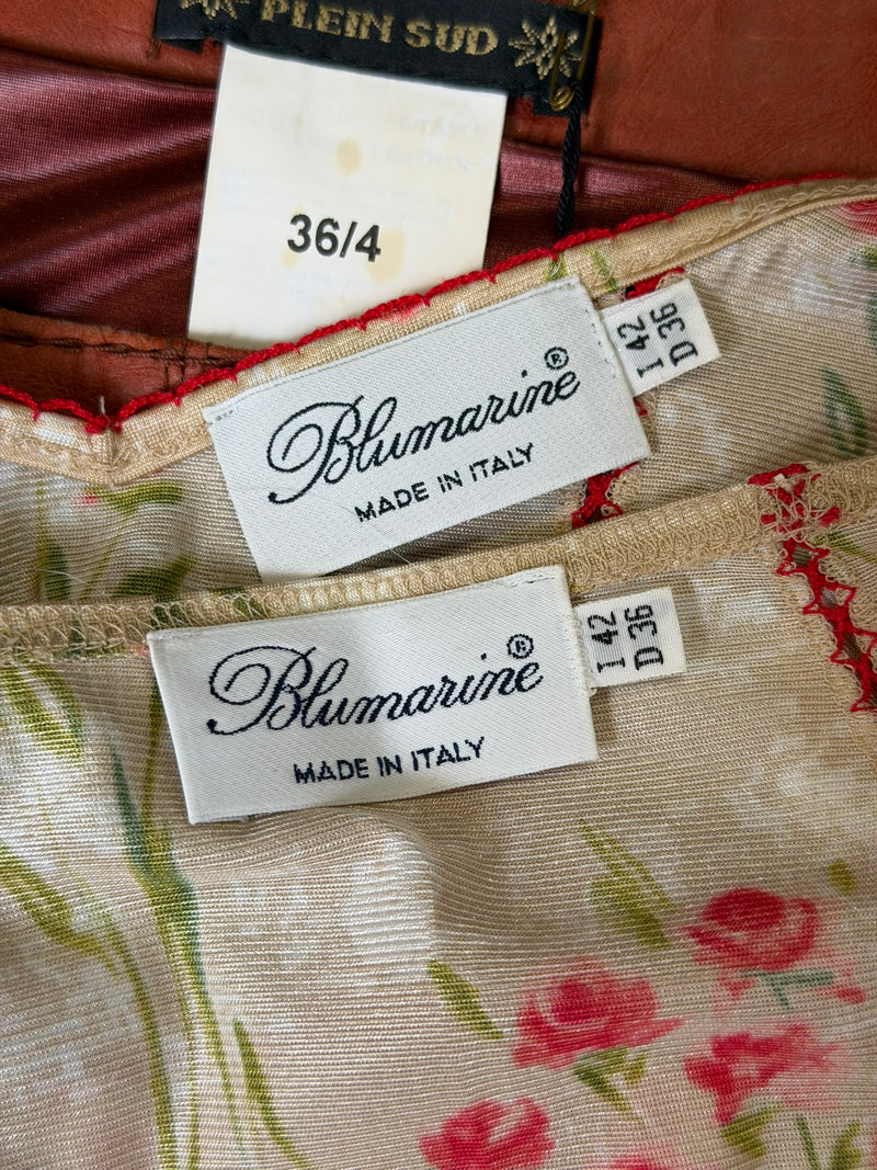 Blumarine two-piece detail showing red piping on seams and lustrous silk fabric texture
