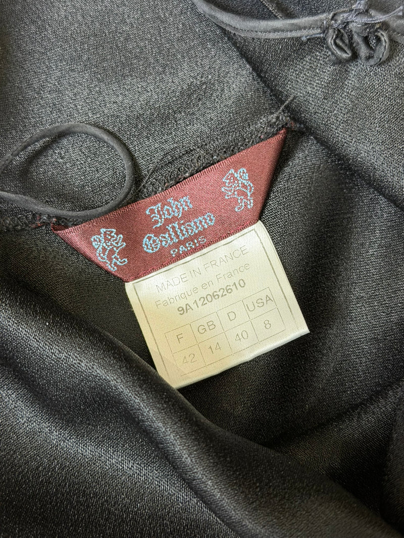 Black satin slip dress by John Galliano, flat lay showing fabric and construction