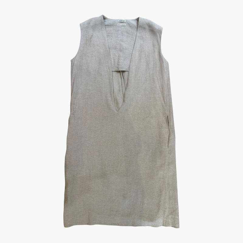Beige linen dress detail showing unfinished seam construction