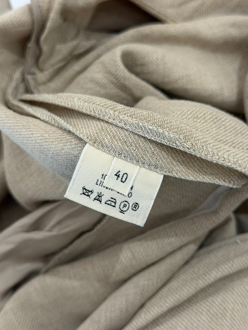 Beige linen V-neck dress, hem and proportions detail