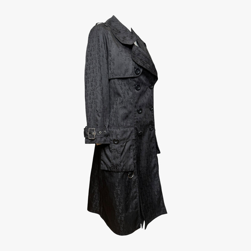 Black monogram jacquard trench coat by Christian Dior, side profile with storm flap detailing