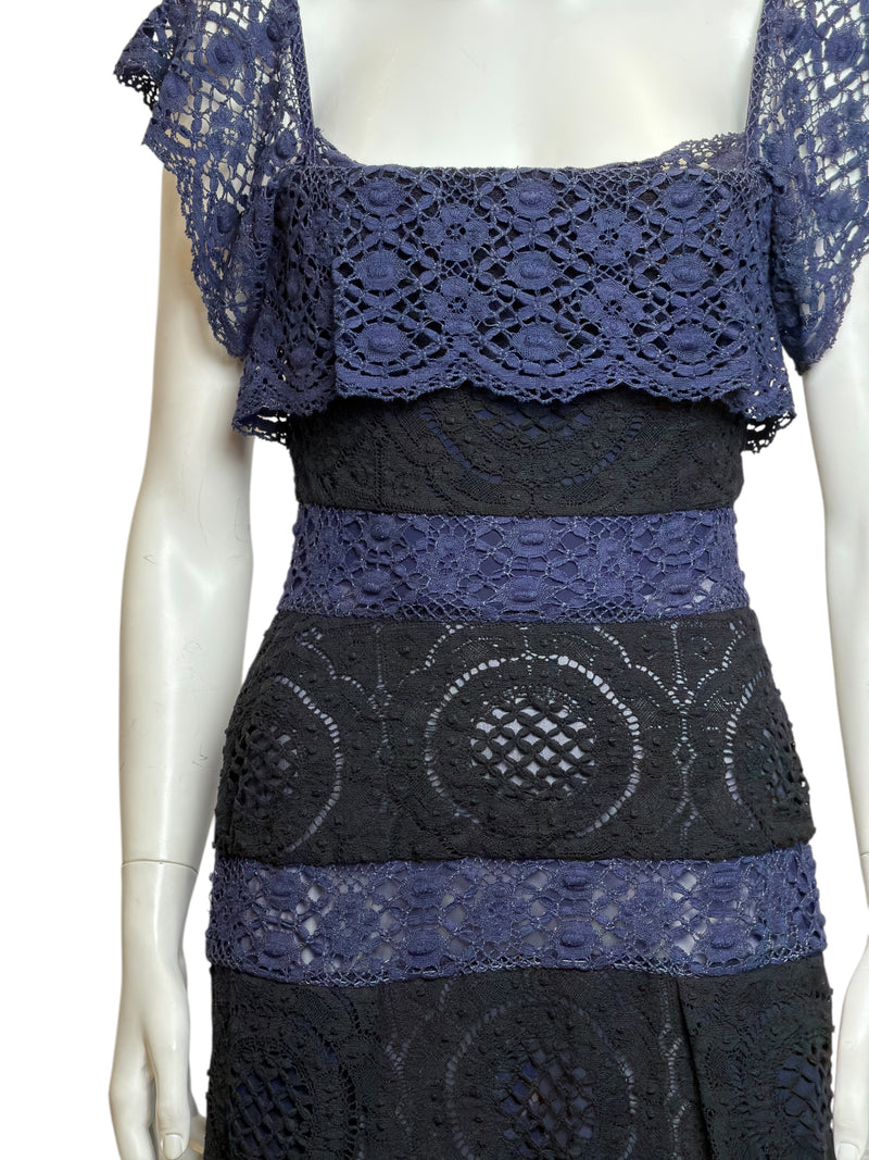 Side view of black and blue lace corseted dress showing fitted bodice and layered construction