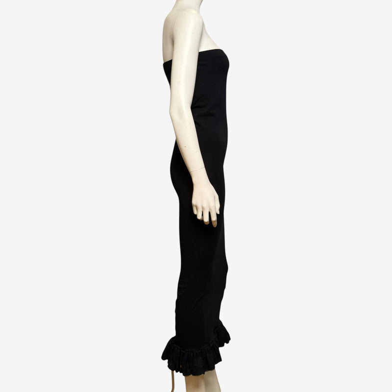 Black strapless tube dress by Dolce & Gabbana, side silhouette showing midi length