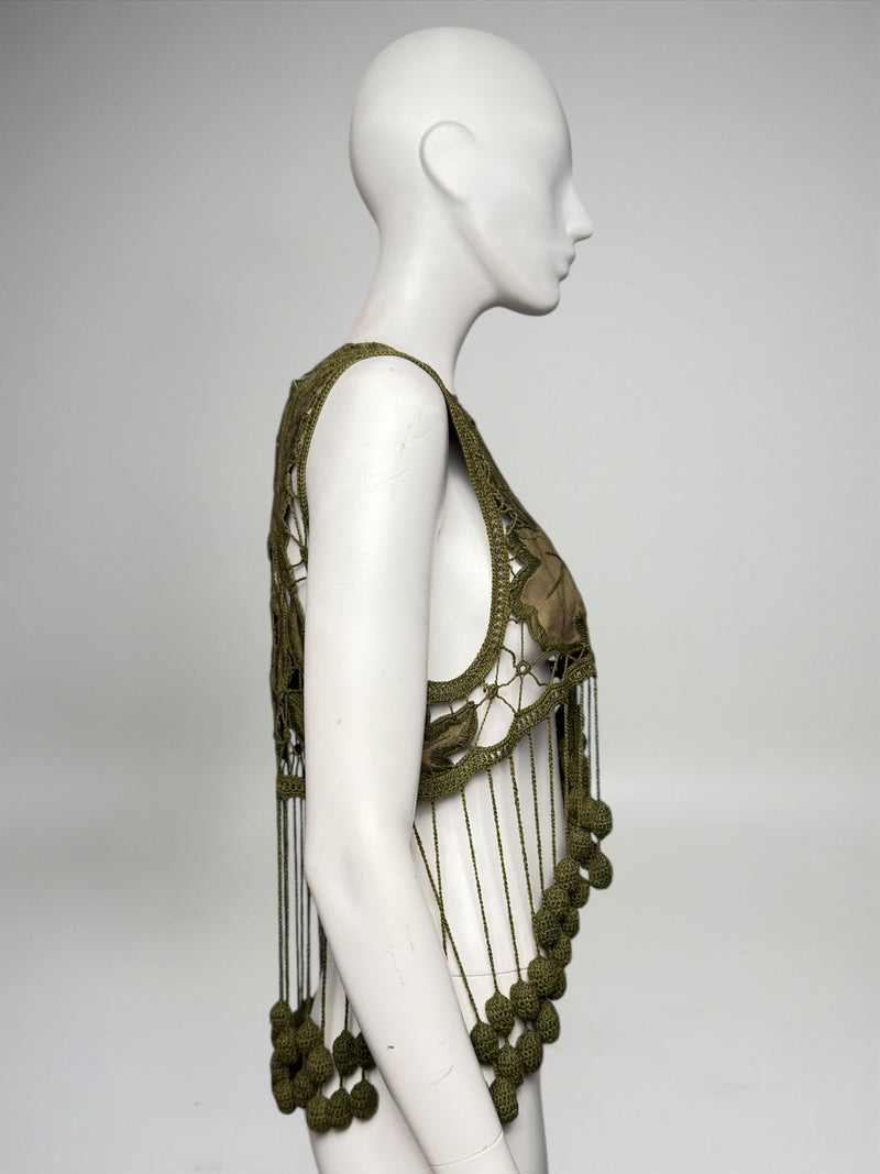 Side view of Romeo Gigli Spring 1990 crochet vest with open construction and knotted cord fringe