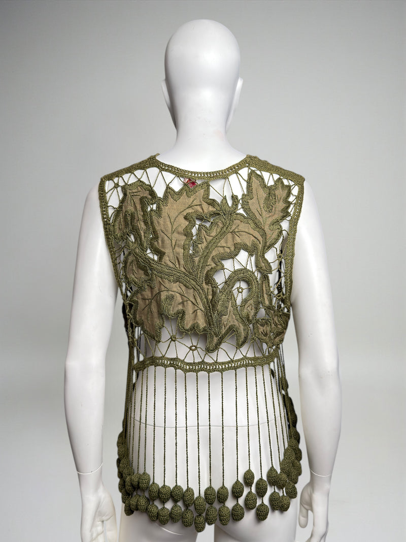 Hem detail of olive crochet vest by Romeo Gigli featuring scalloped fringe with crocheted oval tassels