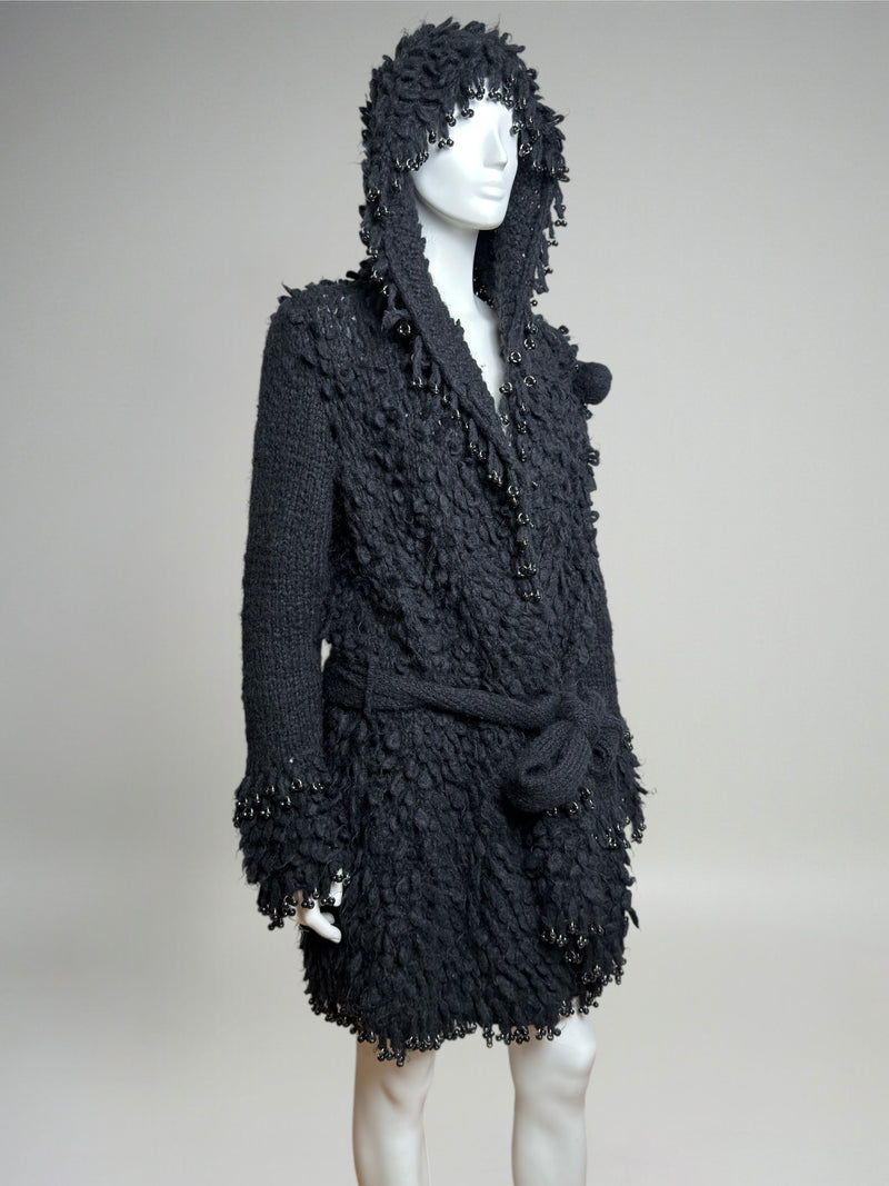 Black wool hooded coat by Paco Rabanne, showing sleeve and cuff construction