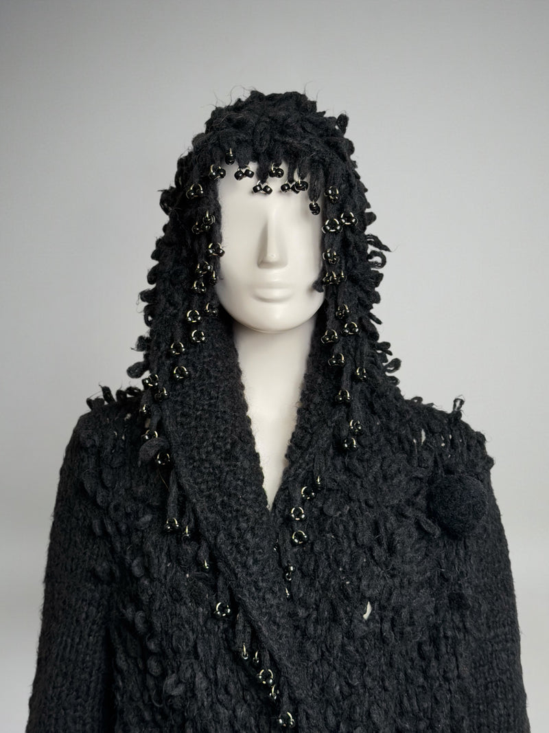 Black wool hooded coat by Paco Rabanne, side profile showing hood structure