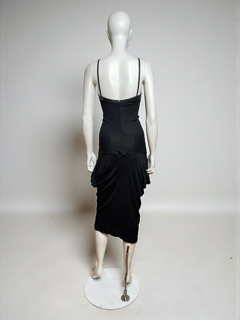 Black leather-cup dress by Alexander McQueen, full-length side view with asymmetrical draping