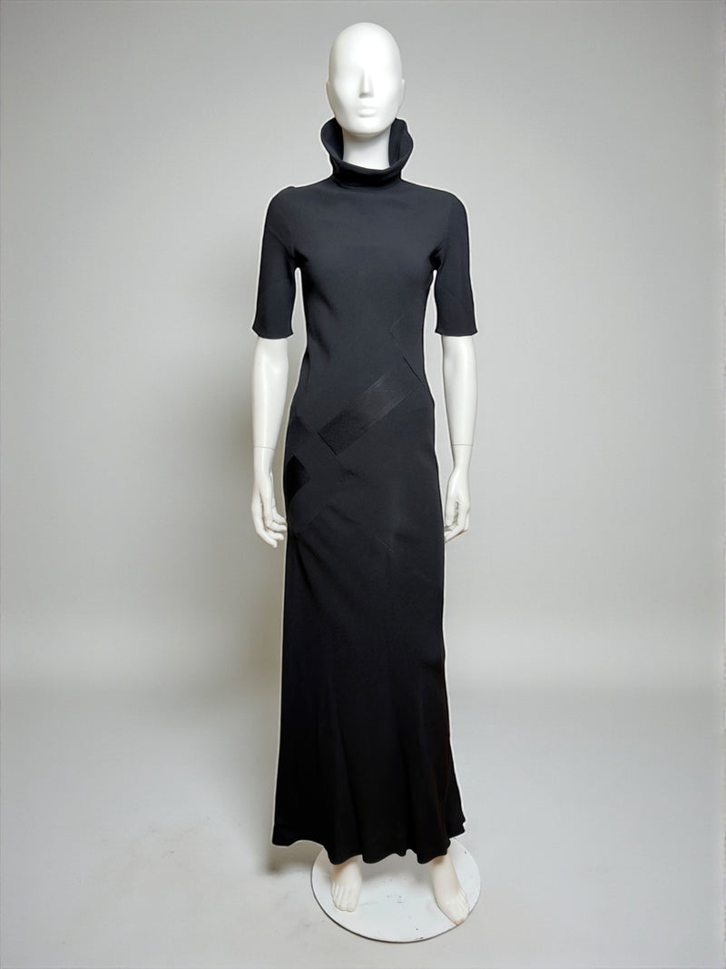 Black bias-cut evening gown by John Galliano, high neckline with floor-length flared hem