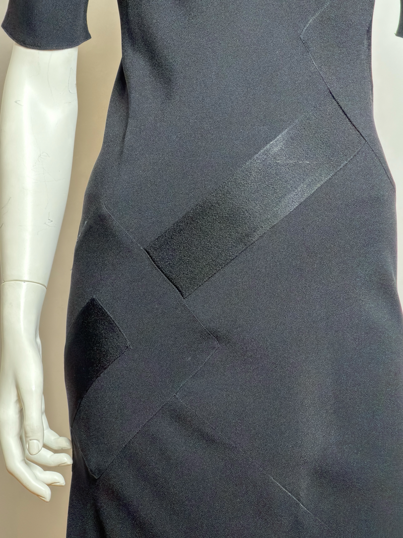 Black evening gown by John Galliano, side profile showing bias-cut construction and neckline