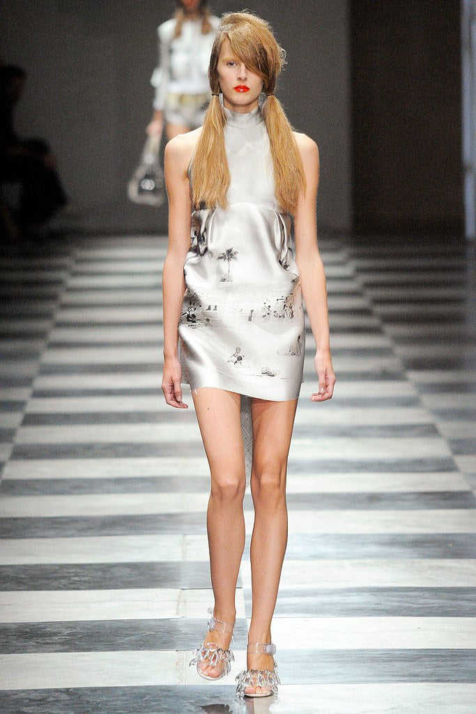 Model wearing cream tropical print halter dress from Prada S/S 2010 runway collection