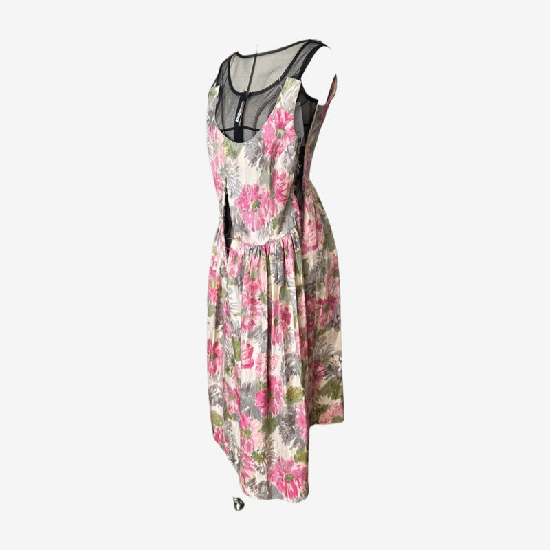 Midi-length floral layered dress by Comme des Garçons, back view with geometric mesh panel