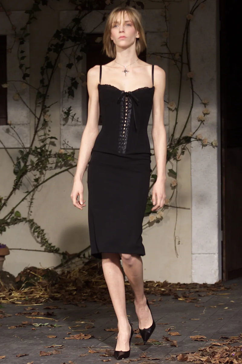 Dolce & Gabbana Fall/Winter 2001 runway look featuring lace-up corset dress with fitted silhouette
